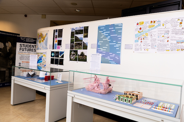 Exhibition display featuring data visualizations, posters, and interactive models
