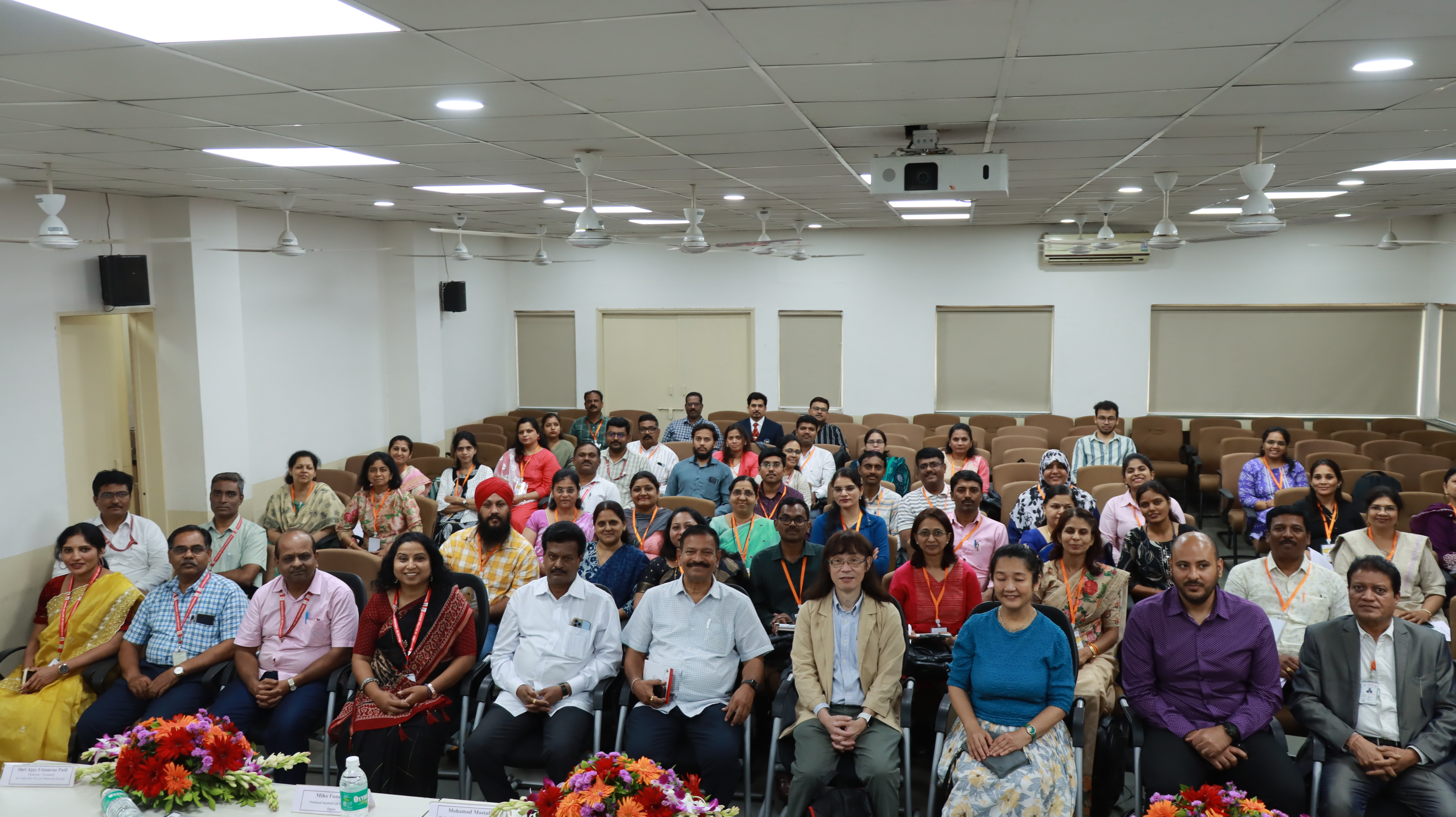 Group photo of attendees at a seminar or workshop in a conference room