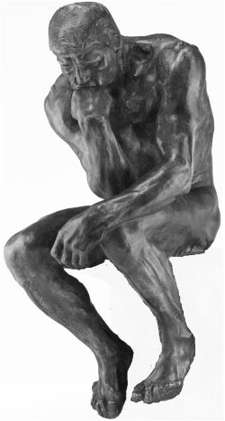 Photo of The Thinker, sitting with chin on hand, by Auguste Rodin