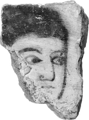 A rough-edged section of wall plaster with a face painted on it