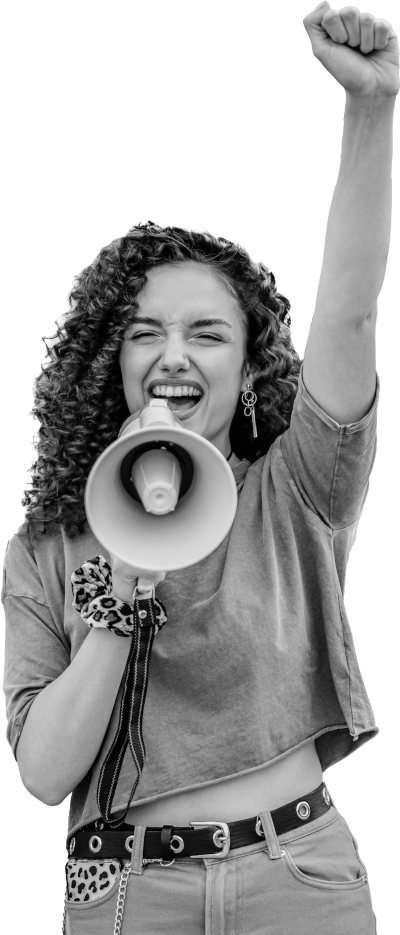 A woman with dark curly hair raises her fist and yells into a megaphone